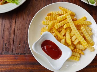 French fries with ketchup on wooden table. Selective focus.