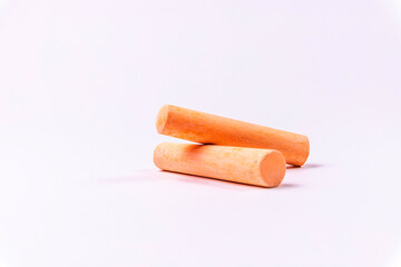 Crayons of different colors arranged on a white background. Education