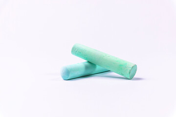 Crayons of different colors arranged on a white background. Education