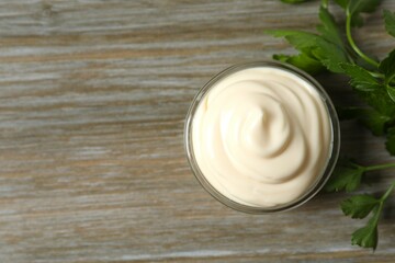 Bowl with mayonnaise on wooden background