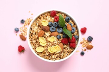 Delicious granola with berries on a color background