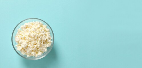 Сottage cheese in a plate on a color background