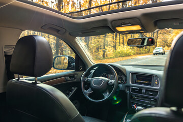 Car view from the inside. Car steering wheel and interior.