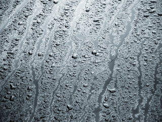 rain water drops on a bonnet of a black car during rainy day