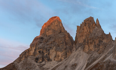 Sunrise alpenglow on the summit of sassolungo in the Dolomite Alps