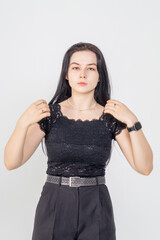 Fototapeta premium Cute young brunette girl standing on a white background. Copy space