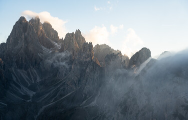 Ridgeline of the Cadini di Misurina mountains with fog rolling over the ridge