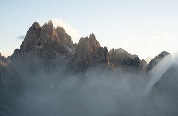 Cadini di Misurina mountains rising above clouds at sunset