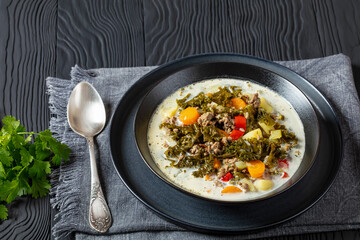 ground beef veggies kale soup in black bowl