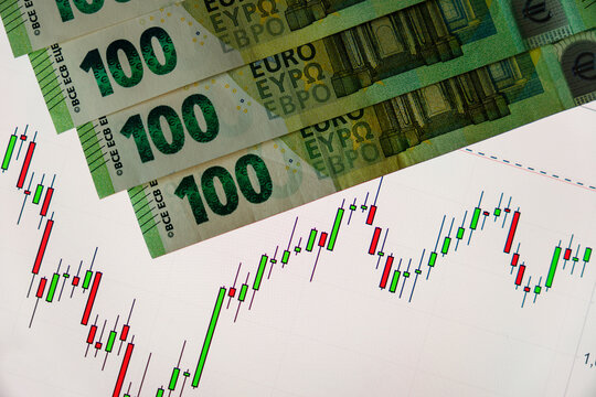 Money banknotes and screen with business chart. US dollar euro market exchange rate on screen