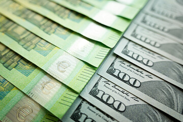 Money, Dollar and Euro. One hundred US dollar banknote over Euro banknotes. Foreign exchange market concept.