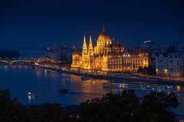 Hungarian Parliament by night. Blue hour night photo with the landmark of Parliament next to Danube river. Concept photo for Budapest, Hungary.