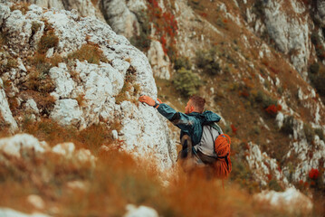 A male climber climbing up on the mountain rock cliff adventure travel adrenaline extreme sport...