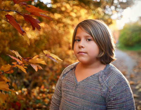 Portrait of transgender non-binary kid outdoors during autumn in nature