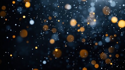 Fototapeta premium Abstract image featuring a bokeh effect with various out-of-focus light dots in blue and orange on a dark background.
