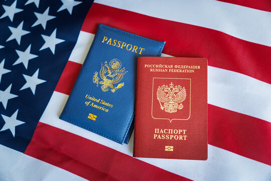 the concept of dual citizenship. Red Passport of Russia Russian Federation - Cyrillic labels and Blue passport of USA United states of America on the US flag