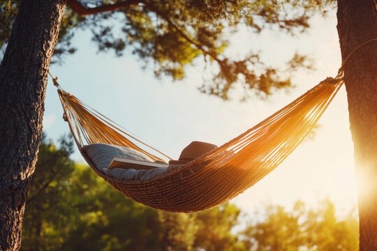 A person is relaxing in a hammock under a tree