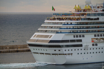 Modern Italian cruiseship cruise ship liner Fascinosa during sunset sail away departure from port...