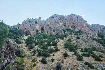 A beautiful landscape with rocks and grottoes. The Anatolian region of Turkey. The time of the year is summer..
