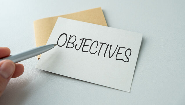 Word writing text OBJECTIVES . Business concept on the notebook