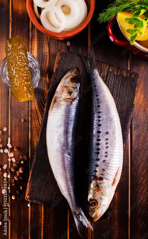 Poster fresh herring with onion on board