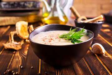 Musroom soup served with parsley leaf.