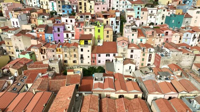 Aerial view of colorful medieval buildings and rooftops in the historic old town, Bosa, Italy.