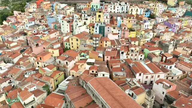Aerial view of colorful medieval rooftops and historic architecture in the picturesque old town, Bosa, Italy.