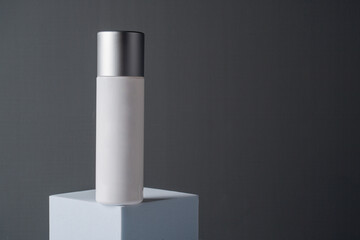 White sunscreen bottle on grey background. Sunscreen concept. Skin care concept. Copy space.