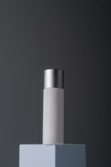 White sunscreen bottle on grey background. Sunscreen concept. Skin care concept. Copy space.
