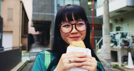 Travel, eating and woman with pastry in city on vacation, adventure or weekend trip for journey....