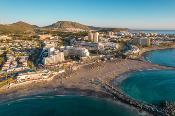 Aerial view of Playa de las Americas beach at sunset, Tenerife, Spain.