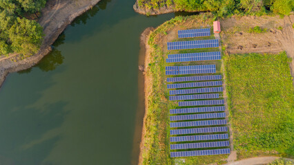 Drone view of solar panel near water reservoir. Aerial Shot of many 