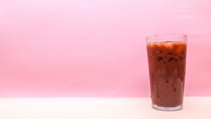 Iced chocolate in clear glass isolated on pink background, copy space blank space