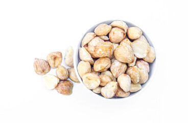 Candlenut or Aleurites moluccanus in a white bowl isolated on white background. Candlenuts are a cooking spice