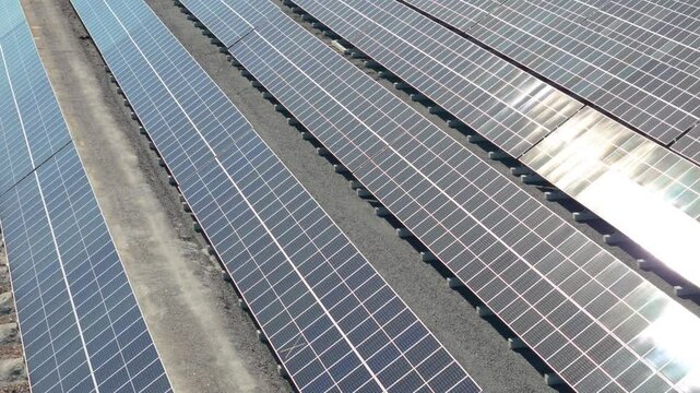 Close aerial of Solar Farm showcasing bifacial solar panels producing clean energy