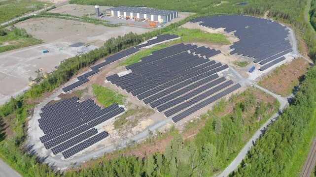 Panoramic overview showcasing bifacial panels and renewable energy at Solar Farm in Finland in oval shaped pattern clearing