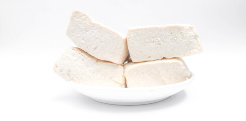 Fresh white tofu cubes on a white plate isolated white background. Fresh soybean tofu.