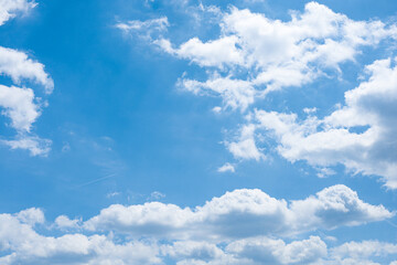 Fluffy, bright clouds and blue summer sky background.