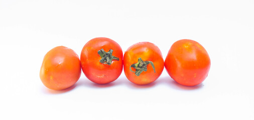 Set of red tomatoes with leaves isolated on white background. Close up of fresh ripe tomatoes