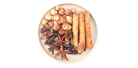 Group of cardamom, cinnamon, star anise, anise seed, clove, coriander seeds, isolated on white background. Gather natural spices in one plate