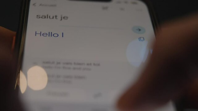 Close-up view of a smartphone screen showing a translation app in use, highlighting multilingual communication, technology, and the ease of real-time text translation.