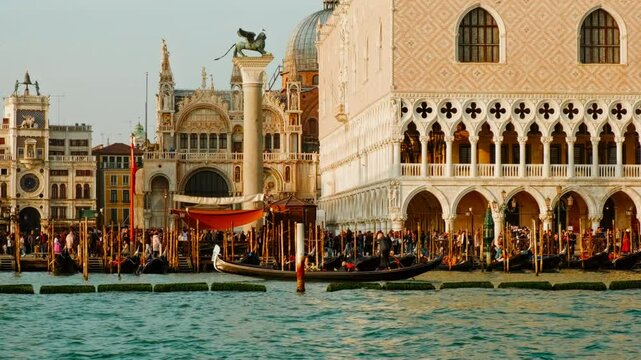 Establishing shot of Venice, Italy, revealing the Palazzo Ducale (Doge's Palace), Piazza San Marco (St Mark's Square) and the famous gondolas.