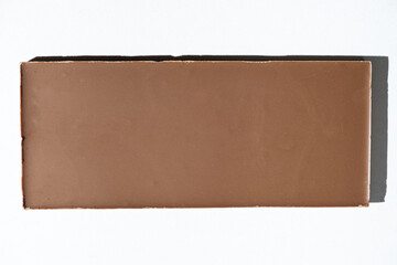 Texture milk chocolate bar on white background top view