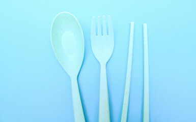Utensils set colorful fork, chopstick and spoon isolated on blue background
