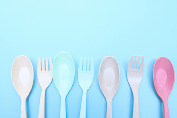 Utensils set colorful fork, and spoon isolated on blue background