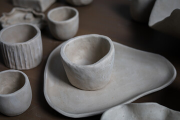 Handmade dishes made of clay on wooden background