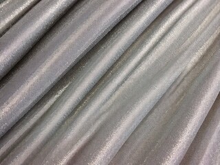 Fototapeta premium Metallic silver fabric with shimmering pleats.
