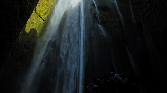 Tourist attraction Gljufrabui hidden waterfall in a narrow canyon in Iceland. The waterfall cascades into a pool near the famous Seljalandsfoss.
