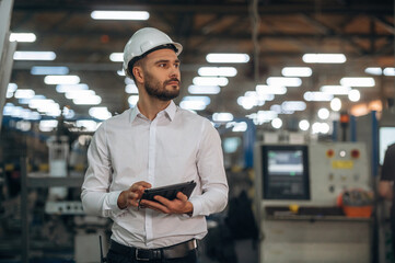 Modern digital tablet. Man is working in the modern factory